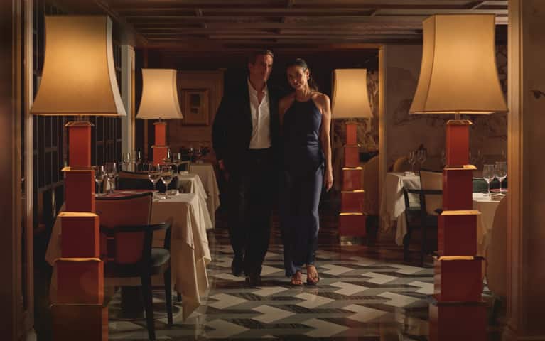 Couple on board Oceania Allura enjoying included specialty dining.