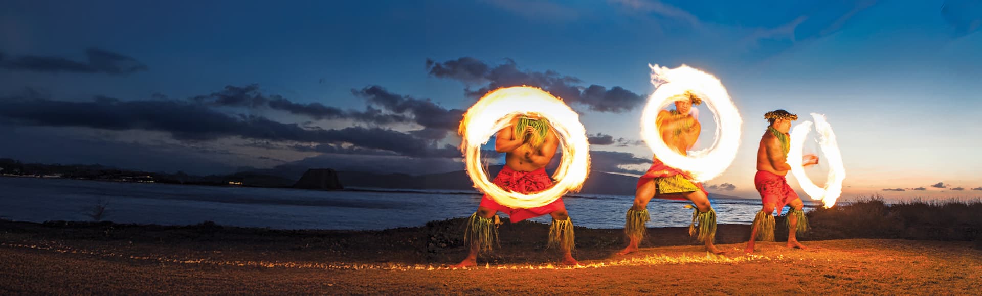 Cruises to South Pacific, fire spinning on beach