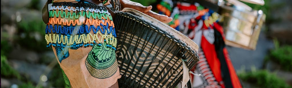 Experience West African griots play traditional djembe drums on an Oceania Cruises shore excursion.