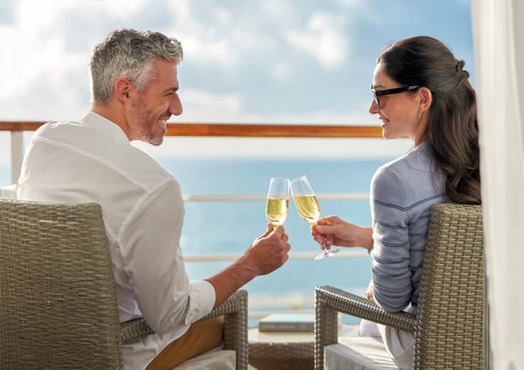 couple on balcony, enjoying champagne