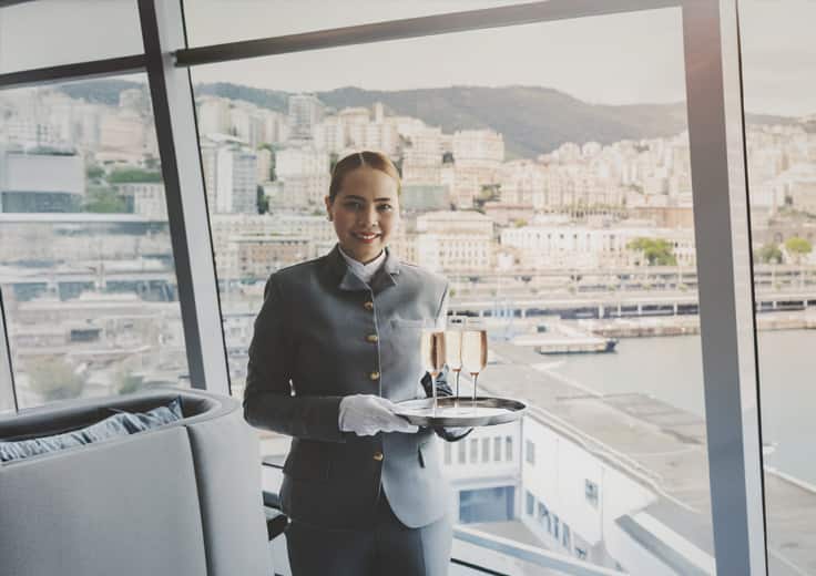 Genuine Hospitality on board Oceania Cruises. A server with a smile.